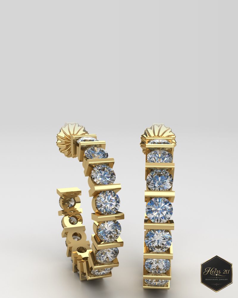 A pair of yellow gold hoop earrings with round diamonds held in a row of bar settings