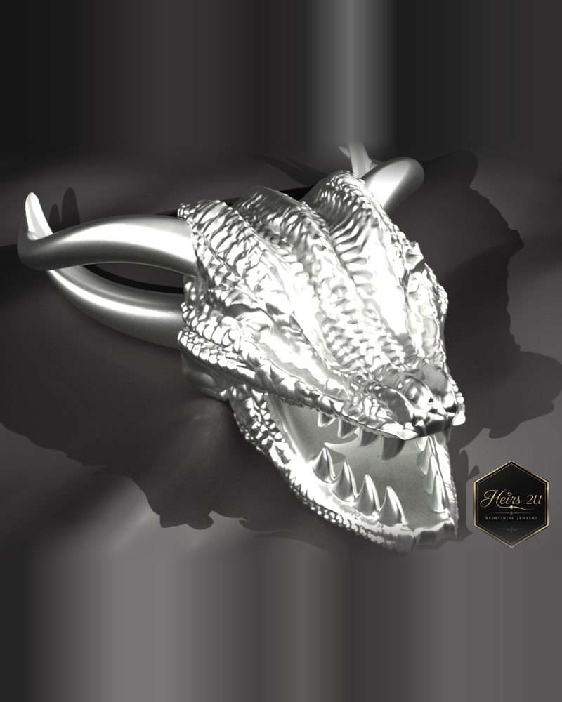 A sculpted silver-coloured dragon head pendant modelled in fine scale detail