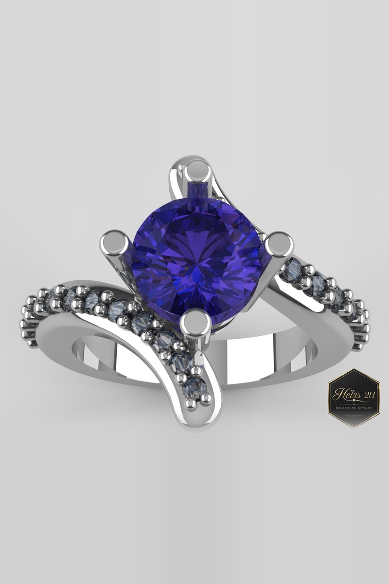 White metal bypass ring with a round violet tanzanite centre stone and dark pavé accents on both shoulders