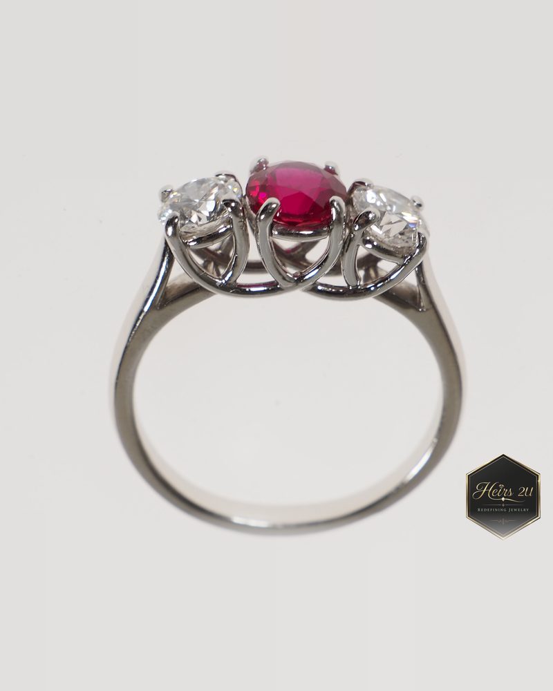 White metal three-stone trellis ring with a round ruby between two diamonds